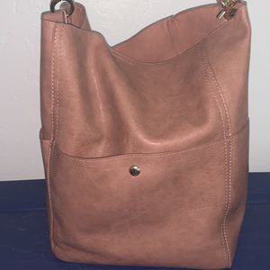 Brownish, pink purse. No pockets inside, but 3 on outside of bag